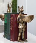 Decorative bookends shaped like a fox and a rabbit holding books on a white surface.