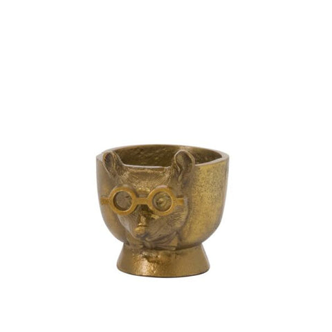 Bronze-colored egg cup with a face design on a white background