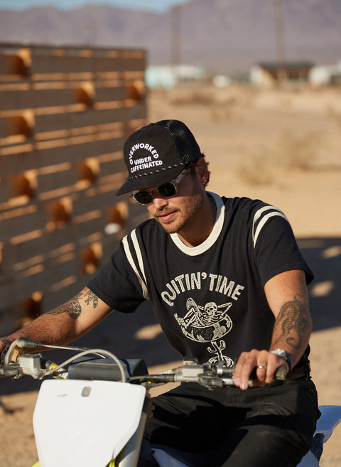 Overworked Under Caffeinated Trucker Hat by Pyknic