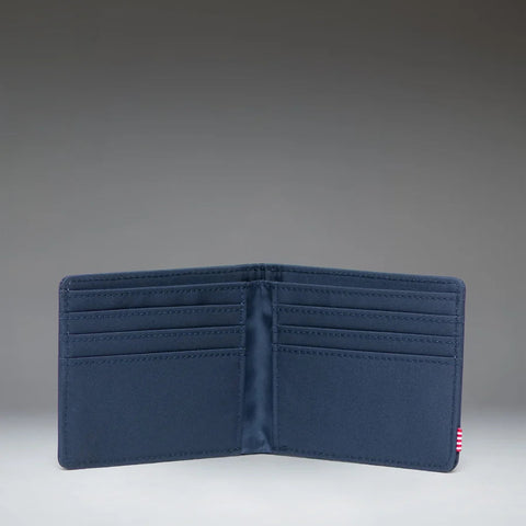 A dark navy blue bifold wallet shown open against a gradient gray studio background.