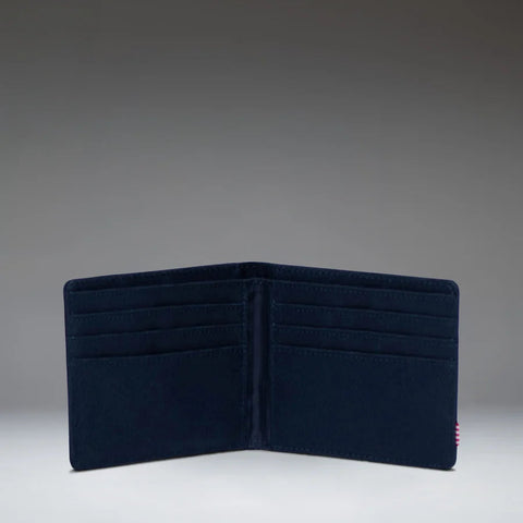 A dark navy blue bifold wallet shown open against a gradient gray studio background.